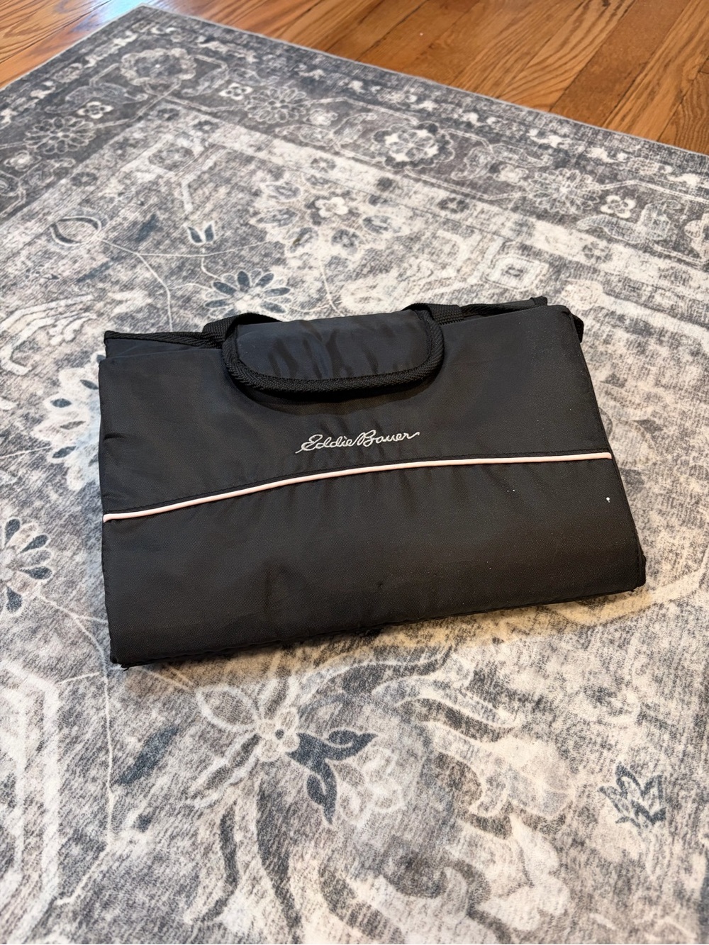 Eddie Bauer Black Foldable portable baby changing pad with Pink Piping